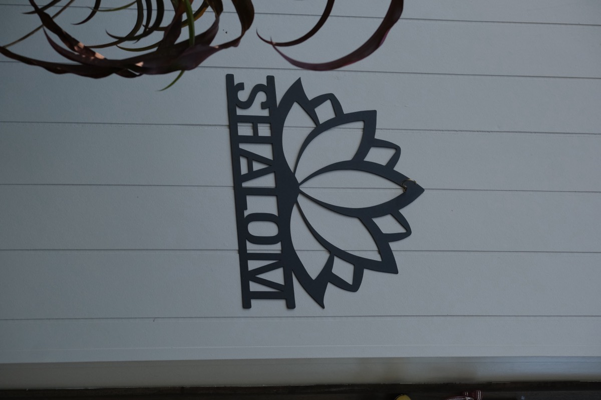 The Shalom lotus sign on the studio wall